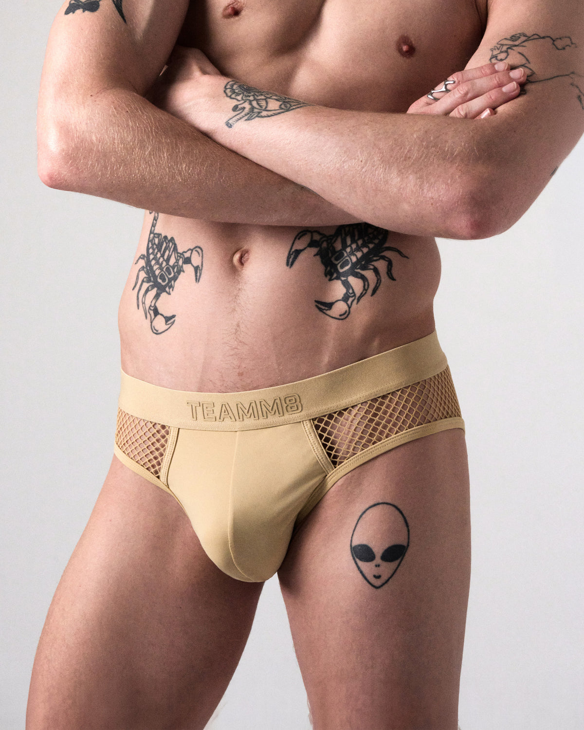 Edge Net Brief in Sand, front close-up of the pouch, tone-on-tone TEAMM8 waistband and net sides