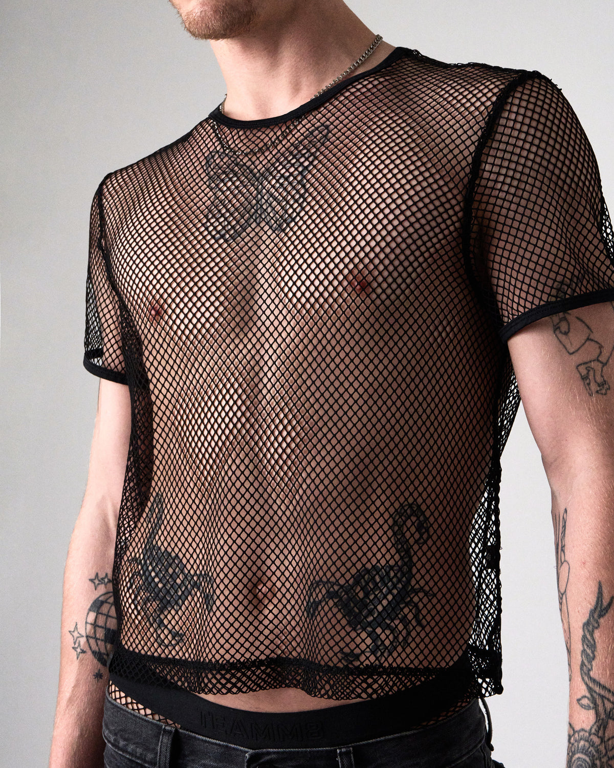 Edge Net Cropped Tee in Jet, front close-up showing the piped neck and sleeves