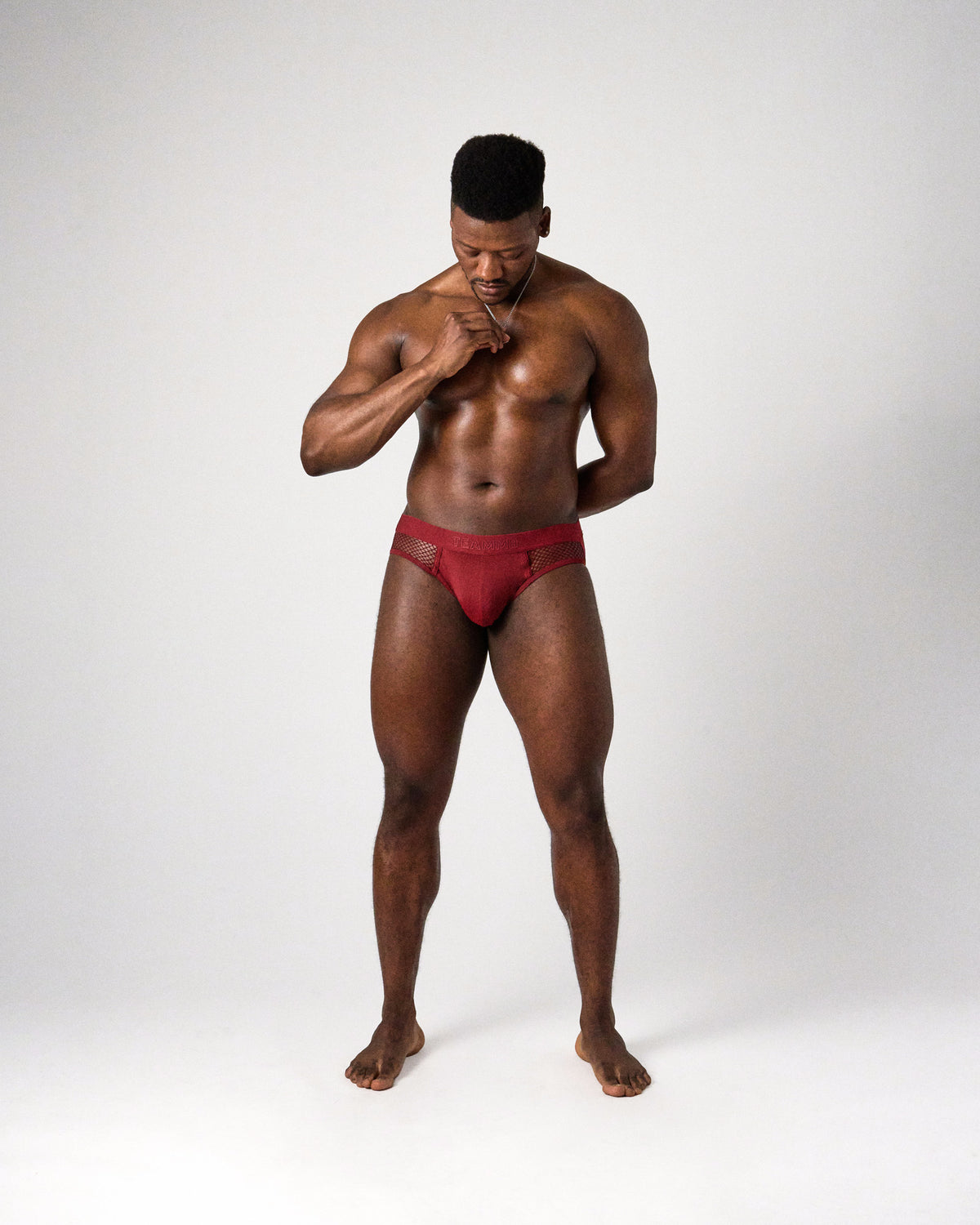 Edge Net Jock/Thong in Maroon, full-length front view on model looking down