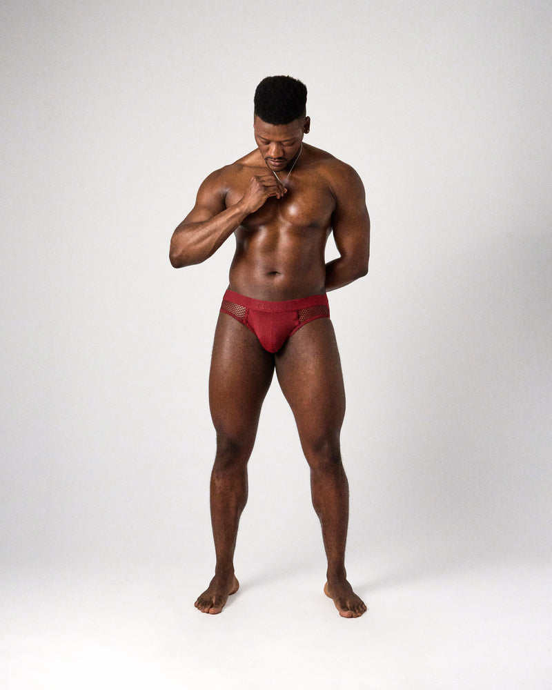 Edge Net Jock/Thong in Maroon, full-length front view on model looking down
