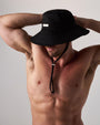 Man wearing a black bucket hat against a plain background
